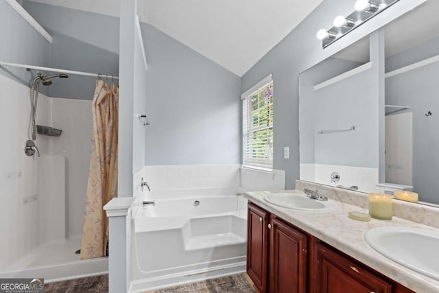 154 Stephens Mill Dr, Dallas, GA 30157 - bathroom with a shower stall, vaulted ceiling, a bath, and double vanity