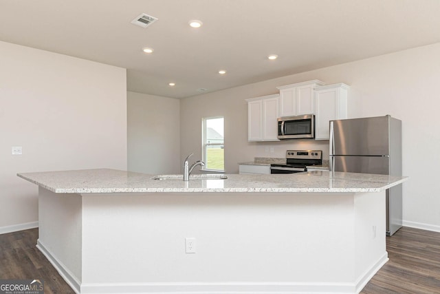 268 Oliver Dr, Locust Grove, GA 30248 - kitchen with appliances with stainless steel finishes, a sink, a spacious island, dark wood-style flooring, and recessed lighting