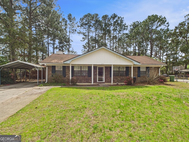 292 Whitetail Cir, Hinesville, GA 31313 - ranch-style house featuring a carport, a front yard, brick siding, and driveway