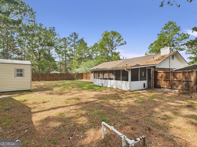 292 Whitetail Cir, Hinesville, GA 31313 - fenced backyard with a sunroom and a storage shed