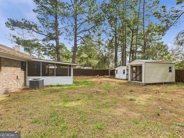 292 Whitetail Cir, Hinesville, GA 31313 - fenced backyard with a storage shed and a sunroom