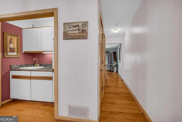 327 Brucken Strasse Unit 609, Helen, GA 30545 - hallway with a sink, light wood-type flooring, and baseboards