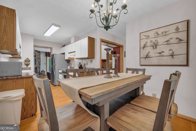 327 Brucken Strasse Unit 609, Helen, GA 30545 - dining space featuring light wood finished floors and a chandelier