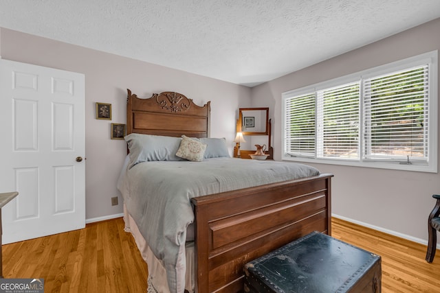 327 Brucken Strasse Unit 609, Helen, GA 30545 - bedroom featuring light wood-style floors, baseboards, and a textured ceiling