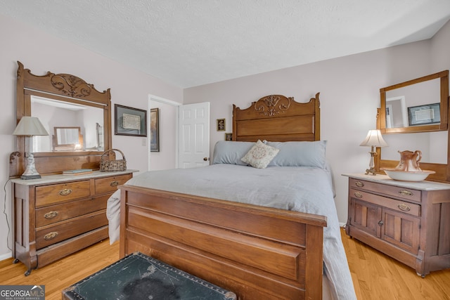 327 Brucken Strasse Unit 609, Helen, GA 30545 - bedroom with light wood finished floors and a textured ceiling