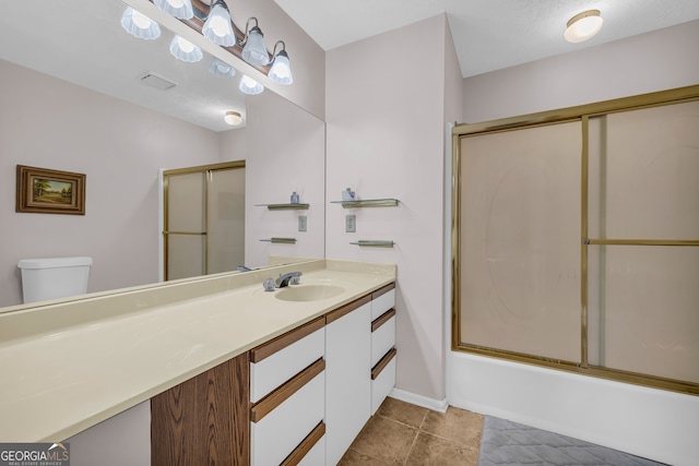 327 Brucken Strasse Unit 609, Helen, GA 30545 - full bath featuring vanity, toilet, bath / shower combo with glass door, tile patterned floors, and baseboards