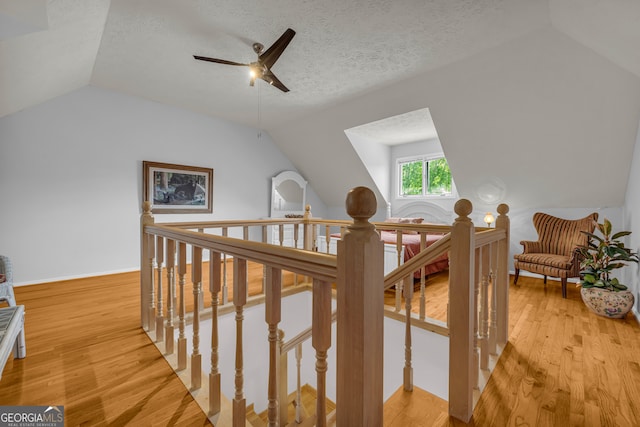 327 Brucken Strasse Unit 609, Helen, GA 30545 - hall featuring lofted ceiling, an upstairs landing, light wood-style floors, a textured ceiling, and baseboards