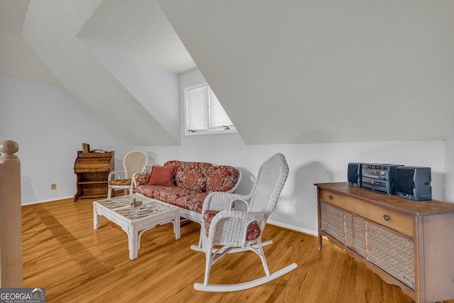 327 Brucken Strasse Unit 609, Helen, GA 30545 - living area featuring wood finished floors, vaulted ceiling, and baseboards