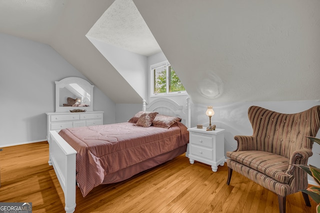 327 Brucken Strasse Unit 609, Helen, GA 30545 - bedroom with vaulted ceiling, light wood-type flooring, and baseboards