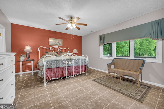 327 Brucken Strasse Unit 609, Helen, GA 30545 - tiled bedroom featuring baseboards, a textured ceiling, and a ceiling fan