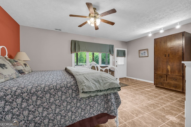 327 Brucken Strasse Unit 609, Helen, GA 30545 - bedroom featuring a textured ceiling, light tile patterned floors, a ceiling fan, and track lighting