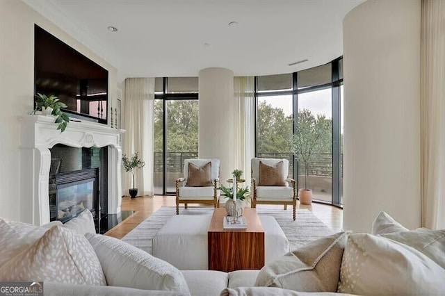 750 Park Ave NE Unit 6E, Atlanta, GA 30326 - living room with a wall of windows, a fireplace with flush hearth, and wood finished floors