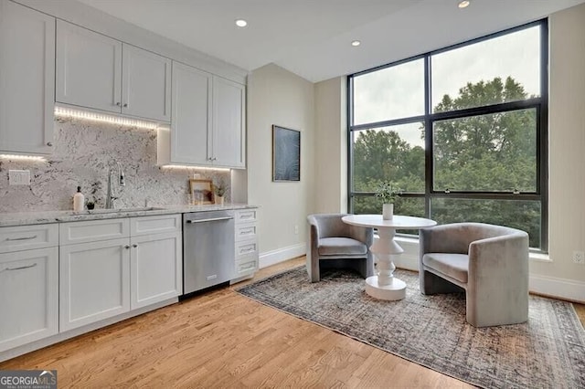 750 Park Ave NE Unit 6E, Atlanta, GA 30326 - kitchen featuring dishwasher, backsplash, white cabinets, light wood-type flooring, and recessed lighting