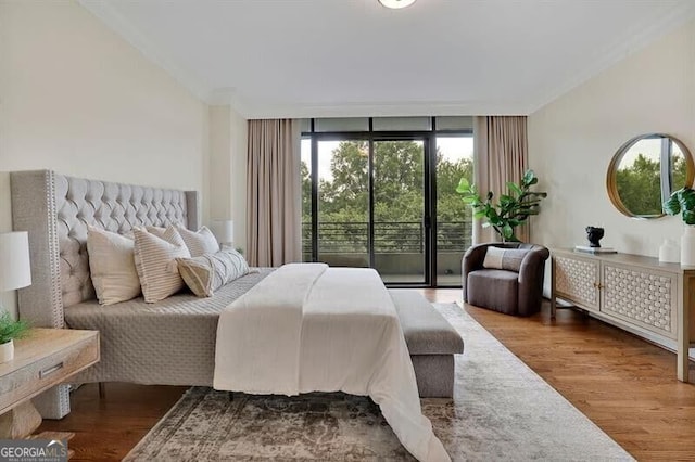 750 Park Ave NE Unit 6E, Atlanta, GA 30326 - bedroom featuring access to exterior, a wall of windows, and wood finished floors