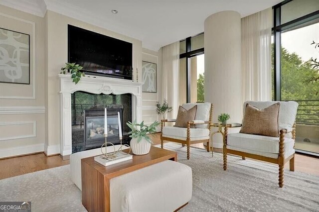 750 Park Ave NE Unit 6E, Atlanta, GA 30326 - living room featuring healthy amount of natural light, wood finished floors, and a glass covered fireplace