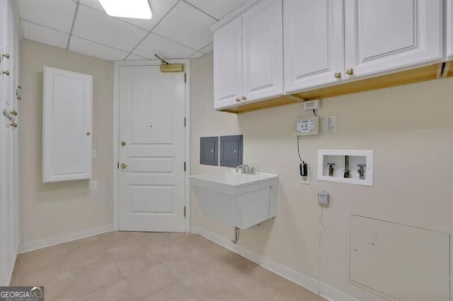 750 Park Ave NE Unit 6E, Atlanta, GA 30326 - laundry room featuring hookup for a washing machine, cabinet space, and light tile patterned flooring
