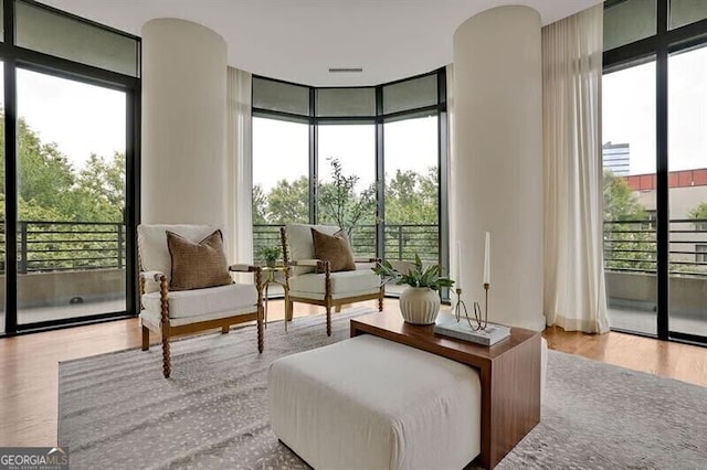 750 Park Ave NE Unit 6E, Atlanta, GA 30326 - sitting room with floor to ceiling windows and wood finished floors
