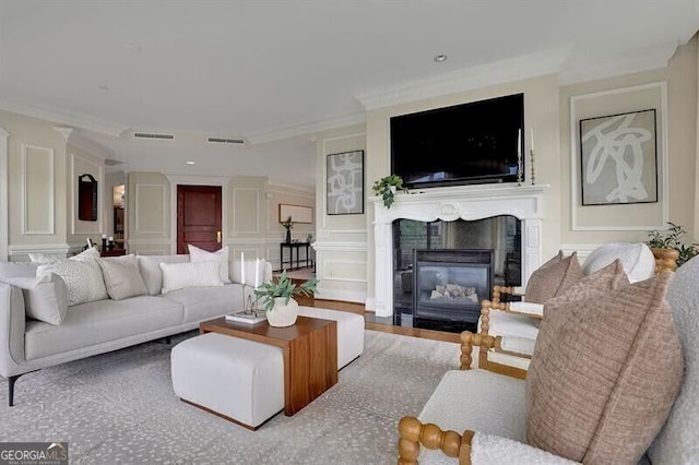 750 Park Ave NE Unit 6E, Atlanta, GA 30326 - living room featuring a decorative wall, a fireplace with flush hearth, and ornamental molding