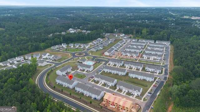 124 Saginaw Ct, Locust Grove, GA 30248 - aerial view of property and surrounding area with a forest and nearby suburban area