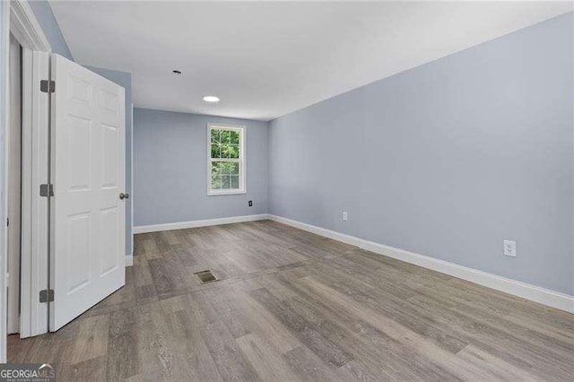 2158 Huckleberry Ln, Lithia Springs, GA 30122 - spare room featuring baseboards, wood finished floors, and recessed lighting
