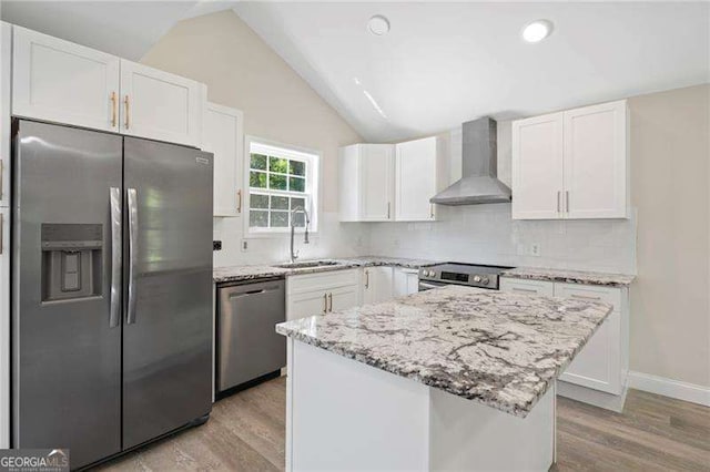 2158 Huckleberry Ln, Lithia Springs, GA 30122 - kitchen featuring stainless steel appliances, wall chimney exhaust hood, a sink, light wood-type flooring, and white cabinetry