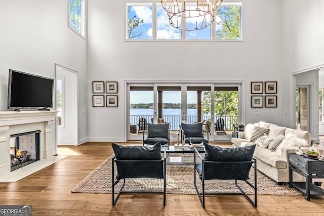117 W View Way, Eatonton, GA 31024 - living room with a high ceiling, a chandelier, healthy amount of natural light, and a fireplace with flush hearth