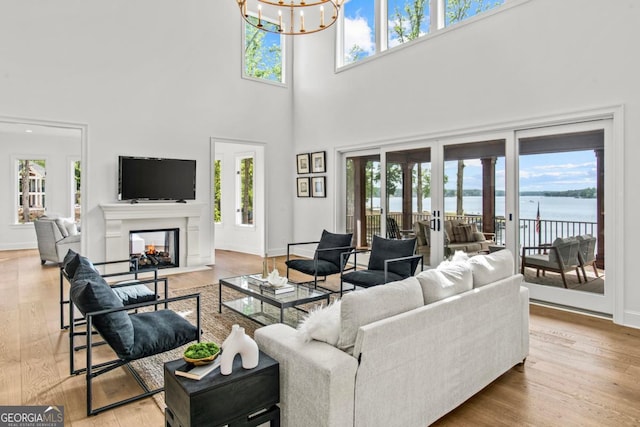 117 W View Way, Eatonton, GA 31024 - living room with a towering ceiling, a chandelier, a multi sided fireplace, and wood finished floors