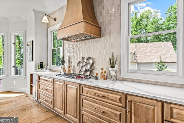 117 W View Way, Eatonton, GA 31024 - kitchen with custom exhaust hood, stainless steel gas cooktop, light wood-style flooring, decorative backsplash, and light stone countertops