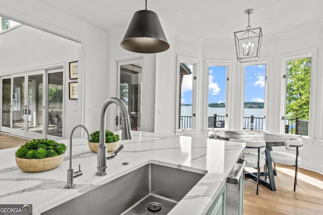 117 W View Way, Eatonton, GA 31024 - kitchen with a water view, light stone counters, decorative light fixtures, a chandelier, and light wood finished floors
