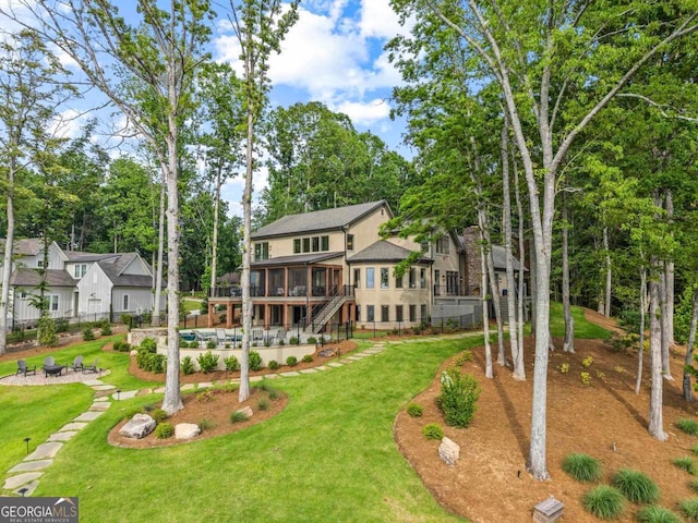 117 W View Way, Eatonton, GA 31024 - back of house featuring a sunroom, a fire pit, a patio, stairway, and view of scattered trees