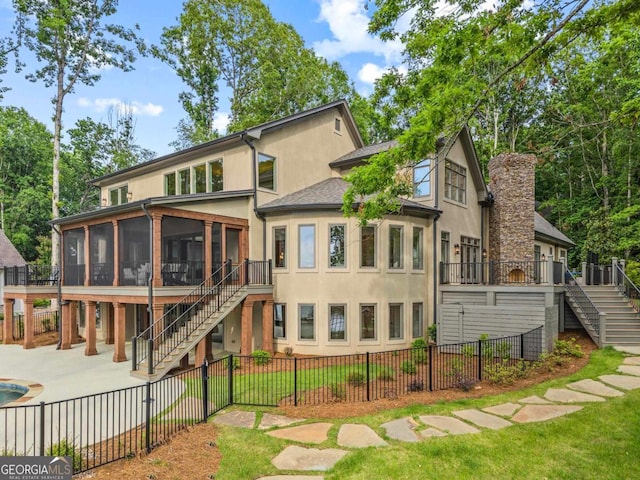 117 W View Way, Eatonton, GA 31024 - rear view of house with stairway, a sunroom, a fenced backyard, and stucco siding