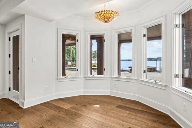 117 W View Way, Eatonton, GA 31024 - unfurnished sunroom with a water view, wood finished floors, and crown molding