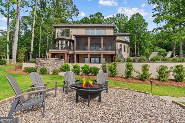 117 W View Way, Eatonton, GA 31024 - back of house featuring an outdoor fire pit, a sunroom, stucco siding, stairway, and a balcony
