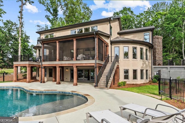 117 W View Way, Eatonton, GA 31024 - back of property with a sunroom, a patio, stairs, and stucco siding