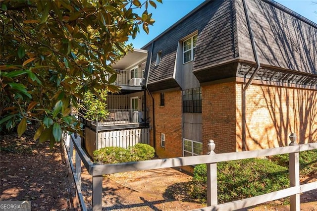 365 Winding River Dr Unit # E, Atlanta, GA 30350 - view of side of property featuring brick siding, mansard roof, and roof with shingles