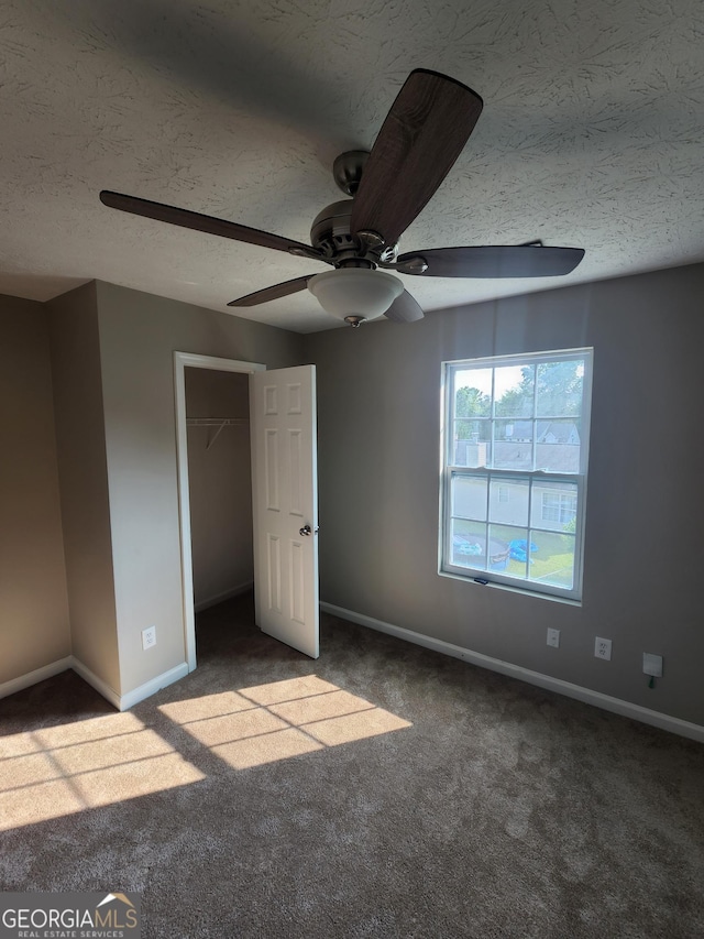 170 Inverness Trce, Riverdale, GA 30274 - unfurnished bedroom with carpet floors, baseboards, a textured ceiling, a ceiling fan, and a closet