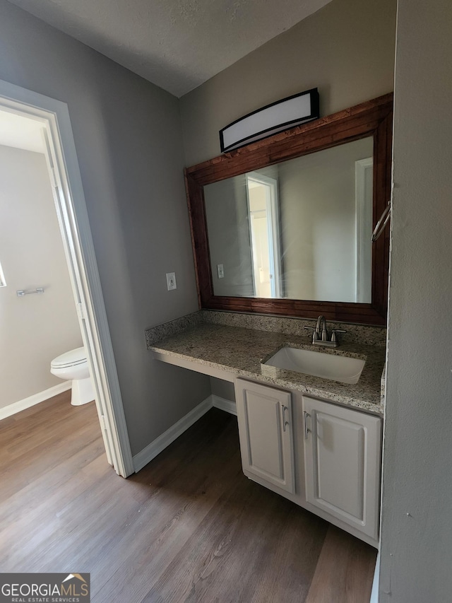170 Inverness Trce, Riverdale, GA 30274 - bathroom with toilet, wood finished floors, vanity, and baseboards