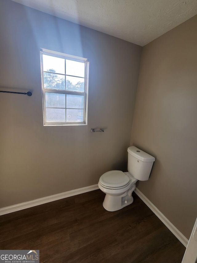 170 Inverness Trce, Riverdale, GA 30274 - bathroom with wood finished floors, toilet, baseboards, and a textured ceiling