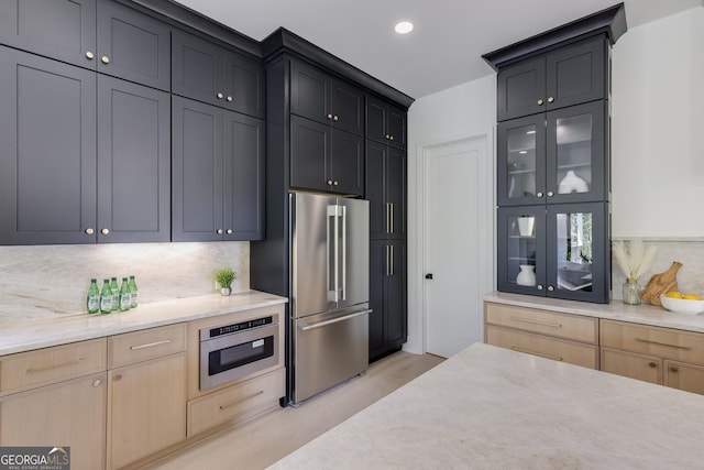 2745 S Bamby Ln NE, Brookhaven, GA 30319 - kitchen featuring high end refrigerator, light wood-type flooring, tasteful backsplash, glass insert cabinets, and wall oven
