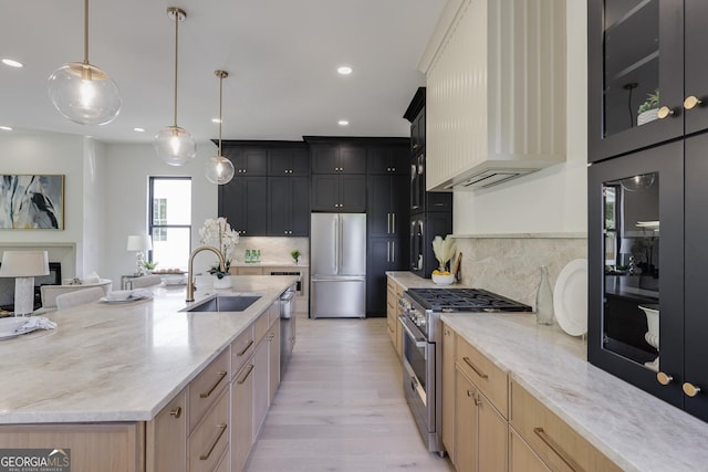 2745 S Bamby Ln NE, Brookhaven, GA 30319 - kitchen with high end appliances, a sink, custom range hood, light wood-style flooring, and light stone counters