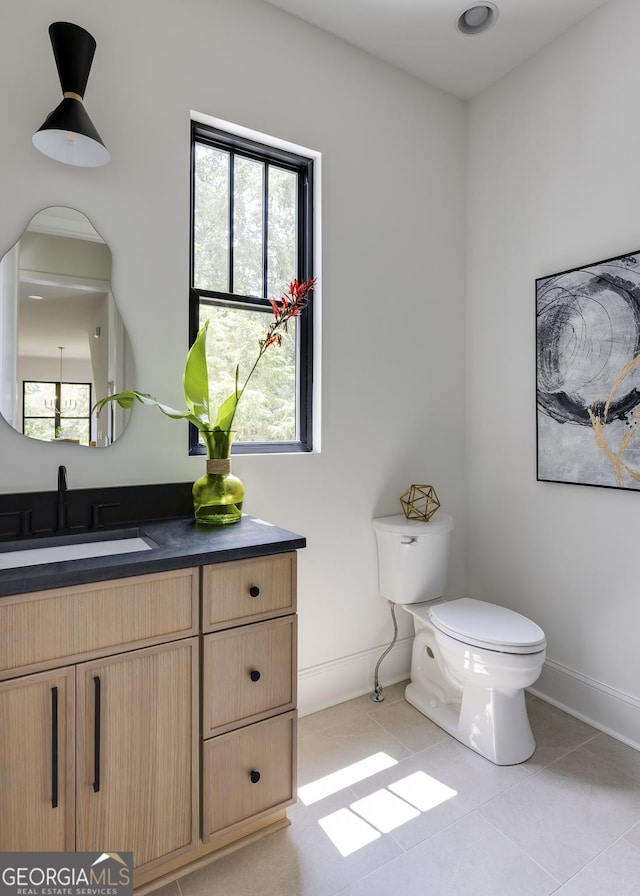 2745 S Bamby Ln NE, Brookhaven, GA 30319 - bathroom with vanity, toilet, tile patterned floors, and baseboards