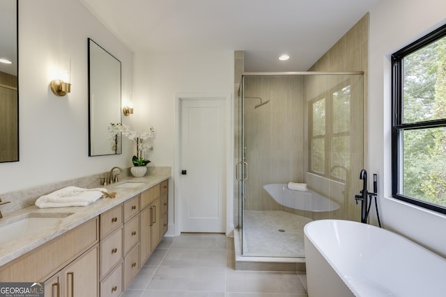 2745 S Bamby Ln NE, Brookhaven, GA 30319 - bathroom featuring a freestanding bath, double vanity, tile patterned flooring, plenty of natural light, and recessed lighting