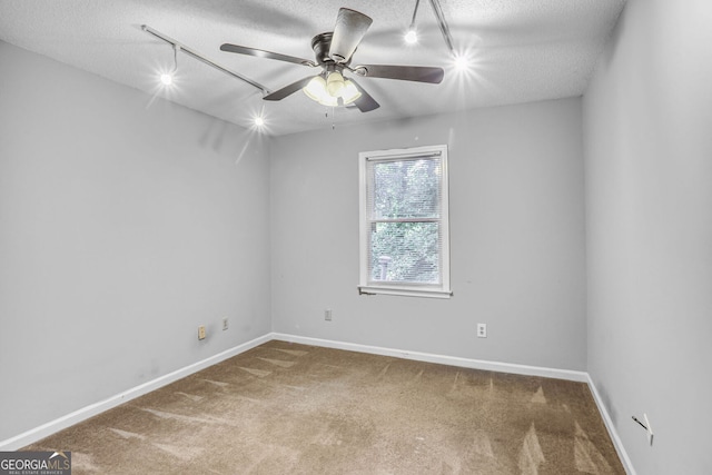 1417 Poplar Pointe SE, Smyrna, GA 30082 - spare room featuring rail lighting, a textured ceiling, carpet flooring, and a ceiling fan