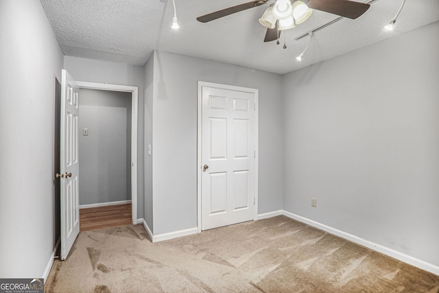 1417 Poplar Pointe SE, Smyrna, GA 30082 - unfurnished bedroom with carpet flooring, a textured ceiling, baseboards, and a ceiling fan