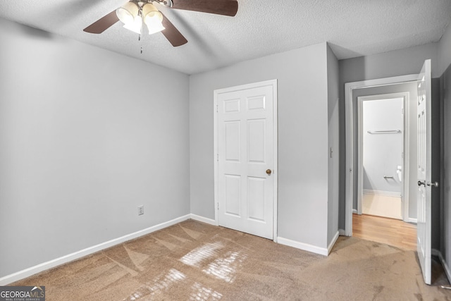 1417 Poplar Pointe SE, Smyrna, GA 30082 - unfurnished bedroom featuring carpet flooring, a textured ceiling, baseboards, and ceiling fan
