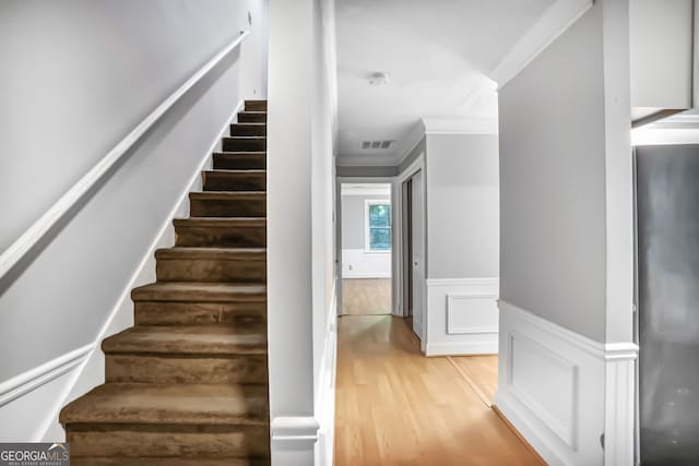 1417 Poplar Pointe SE, Smyrna, GA 30082 - staircase with crown molding, wood finished floors, wainscoting, and a decorative wall