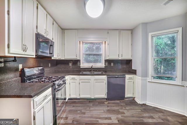 1417 Poplar Pointe SE, Smyrna, GA 30082 - kitchen featuring black appliances, a sink, dark countertops, plenty of natural light, and wainscoting
