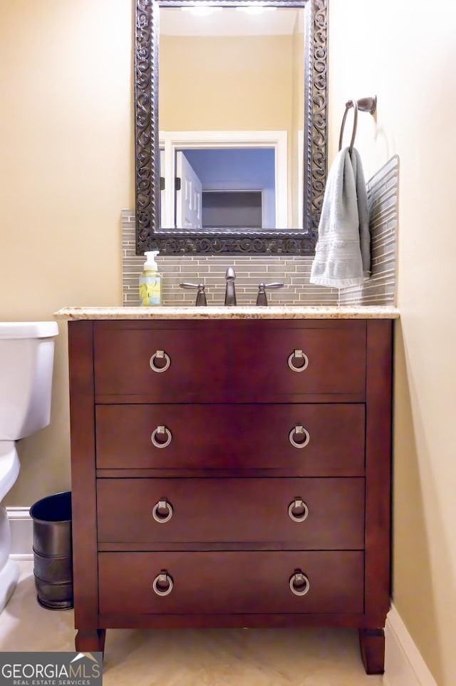 8035 Magnolia Way, Roswell, GA 30075 - bathroom with vanity, decorative backsplash, and toilet
