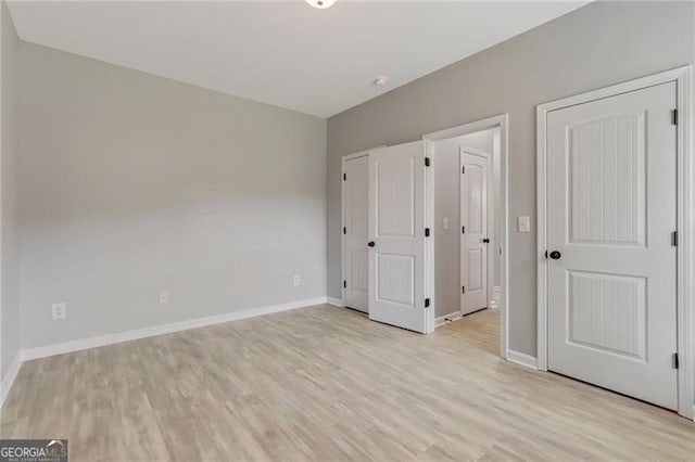 766 Chapman St, Jonesboro, GA 30238 - unfurnished bedroom with light wood-style flooring and baseboards