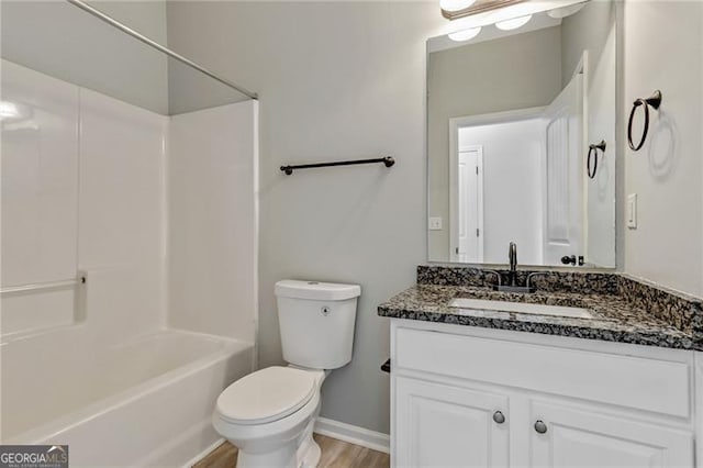 766 Chapman St, Jonesboro, GA 30238 - full bath featuring vanity, toilet, shower / washtub combination, baseboards, and wood finished floors